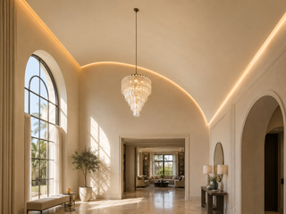 Sweeping curved gypsum ceiling in a double-height villa entrance hall