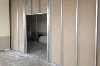Metal C-stud framing skeleton for a gypsum partition wall with doorway opening framed in