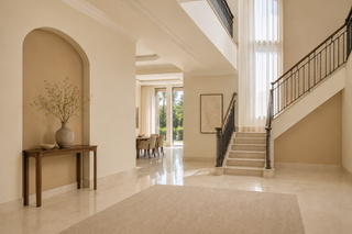 Warm neutral villa interior with antique white and sand tones