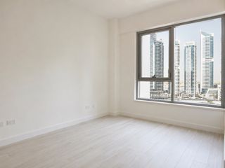 Vacant apartment bedroom with the accent wall reverted to a uniform neutral before tenancy handover